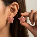 Roze emaille oorknopjes in de vorm van een ster met goudkleurige roestvrijstalen details - Roze