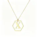 Detail view of gold hexagonal pendant with capital letter X on a delicate chain - Letter X