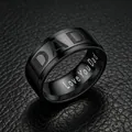 Detail view of 8mm black stainless steel ring with Dad engraving on leather background - Size 7 / Dad Engraved Style / 8mm / Black