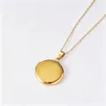 Detailed view of a gold mirror-polished round locket necklace made of stainless steel. - Plain Round Locket (Pinch Bail + Flat Cross Chain) / Gold