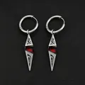 Macro detail of silver hoop earrings featuring red zircon geometric pointed pendants. - Antique Silver Tribal Totem Red Zirconia Earrings (Pair)