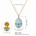 Gold plated copper necklace featuring openable blue egg pendant with floral detail - May Flower
