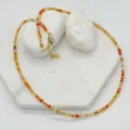 Detail view of handmade faceted orange natural stone necklace with gold-toned spacers - Necklace / 38+5cm / Tan