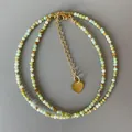 Faceted natural stone beaded necklace with gold spacers and heart charm - Necklace / 38+5cm / Yellow-Green and Gold