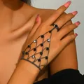 Close-up detail of a gothic black mesh hand chain with rhinestones on a model's hand - Mesh Ring-Linked Style (1005) / Black
