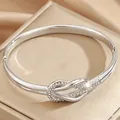 Bracelet jonc élégant en acier inoxydable argenté avec nœud et cristaux brillants pour femmes - Argent