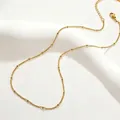 Detailed close-up of gold titanium steel satellite chain necklace with elegant beads - 40+5cm / Satellite Chain (Beaded Curb) / Gold