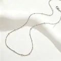 Close-up detail of a minimalist titanium steel satellite beaded chain necklace - 40+5cm / Satellite Chain (Beaded Curb) / Silver