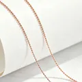 Close-up detail of rose gold titanium steel ball chain necklace on white background - 40+5cm / Ball Chain / Rose Gold