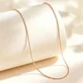 Detailed macro view of a rose gold titanium steel box chain necklace on a minimalist display - 40+5cm / Box Chain / Rose Gold