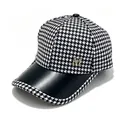 Primo piano di un cappello pied-de-poule con visiera in pelle e emblema M dorato - Adulto (Circonferenza regolabile 58cm) / Nero