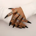 Vintage dark style silver ring set with ethnic symbols on model hands with black nails - F103