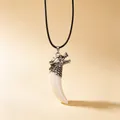 Detailed view of a mens dragon head pendant with resin wolf tooth on black cord - Dragon Head Pendant + Wax Cord