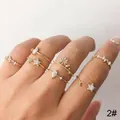Set of 7 gold stackable finger rings with star and moon designs. - Gold Moon Star Rhinestone Knuckle Ring 7-Piece Set (5764) / Gold