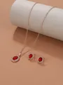 Detailed view of the Baroque jewelry set featuring red gemstones and gold plating. - Rose Gold Red M-146 (2-Piece Set)