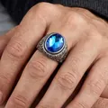 Detailed close-up of vintage engraved titanium steel ring with a bright blue gemstone - US 7 / Steel Color Blue Gemstone