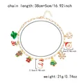 Detailed view of gold Christmas charm necklace with Santa, reindeer and snowflake pendants - Santa Claus Theme Necklace