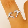 Elegant silver-toned open heart ring featuring pavé set cubic zirconia on a female finger - Hollow Heart Style (7423) / Silver
