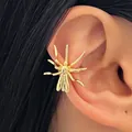 Detail view of a gold spider-shaped ear cuff worn on the ear, gothic Halloween jewelry. - Spider Style (6134) / Gold