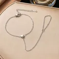Detail of silver stainless steel heart hand chain bracelet showing delicate link texture - Mini Heart Hand Chain Bracelet (E2521)