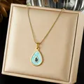 Detail view of an elegant gold waterdrop pendant necklace with light blue enamel inlay. - Teardrop Shape Light Blue Enamel Pendant (N4518)