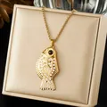 Detail view of a gold-plated goldfish pendant necklace with pearl inlays on a jewelry box - Artificial Pearl Inlaid Goldfish Style (N4519)