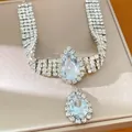 Detail showing sparkling rhinestones and pear-cut crystal on a silver choker necklace. - Silver