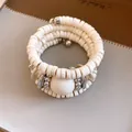 Detailed view of a vintage multilayer wrap bracelet featuring cream beads and silver metal balls - Bracelet (Khaki)