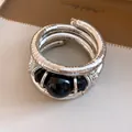 Close-up of a retro silver-tone wrap bracelet with large black acrylic beads - Bracelet (Black/Silver)