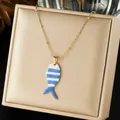 Close-up detail of a charming blue and white striped fish pendant necklace on gold box - Blue and White Striped Fish Enamel Painting (N4530)