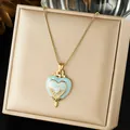 Close-up of elegant gold plated enamel heart pendant necklace with crystal accents - Light Blue White Layered Heart Enamel Pave (N4529)