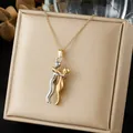 Detailed close-up of a two-tone hugging couple pendant necklace displayed on a beige box - Gold and Silver Contrast Hugging Figure (N4546)