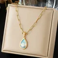 Detailed view of a gold water-drop pendant featuring ocean wave enamel and a central pearl. - Teardrop Shape Ripple Enamel Artificial Pearl Inlaid (N4537)