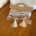 Close-up detail of multi-layered white beaded bracelet set with colorful tassels - 18# Bracelet / White