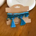 Detailed view of blue resin beaded bracelet set with silk tassels on craft card. - 20# Bracelet / 6-Piece Set / Blue