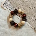 Close-up of vintage beaded bracelet with brown and beige resin beads on rustic linen - 29# Bracelet / White-Coffee