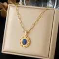 Detail of a vintage gold-plated necklace with an engraved oval lapis lazuli pendant. - Lapis Lazuli Round Carved French Necklace (N4558)