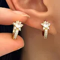 Detail of gold star-shaped huggie earrings featuring sparkling micro-pave cubic zirconia - Star Zirconia Ear Hook (WG-1406)