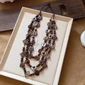 Detail showing multi-layered bohemian necklace with coconut shell geometric beads - Multilayer Geometric Necklace / Brown
