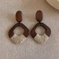 Close-up of geometric wooden earrings with woven twine detail on a rustic linen surface - Style 4 / Brown