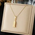 Detailed close-up of gold-plated stainless steel skyscraper pendant on a jewelry box. - 3D Building Geometric Architecture Style (N4539)