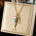 Detailed close-up of a stainless steel necklace with two gold and blue fish pendants - Creative Enamel Double Fish Gold Necklace (N4526)