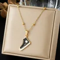 Detailed view of a gold-plated stainless steel necklace with a black sneaker pendant. - Black and White Enamel High-top Sneaker Bead Chain (N4550)