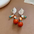 Retro ethnic style earrings with silver leaf tops and large orange wooden beads. - Retro Metal Leaf Style (29#)