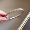 Elegante bracciale rigido dorato con due file di scintillanti cristalli gialli donna - Strass Giallo / Oro