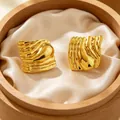 Detailed macro view showing the unique molten metal texture of golden irregular earrings - Pleated Earrings 2 / Gold