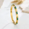 Detailed view of a gold-plated stainless steel bangle with rectangular green crystals - Green Rhinestone Gold Style