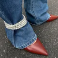 Trendy multi-layer faux pearl anklet worn over denim jeans as a unique fashion accessory - Triple Layer Pearl Style (0901)