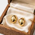 Polished gold dome stud earrings made of stainless steel in a premium wooden gift box - Smooth Oval
