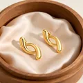 French style abstract twisted gold stud earrings in polished stainless steel finish - Line
